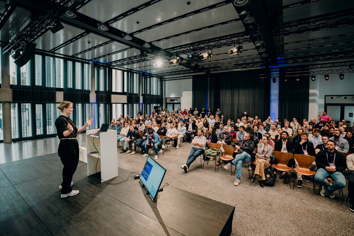 Lilith presenting the AI Operating System to a large audience